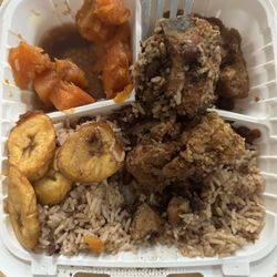 Ignite Cuisine - 1/2 eaten fried chicken with rice and peas, yams, plantains