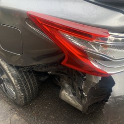 Automotive Support Services - Damaged left side of vehicle near gas tank.