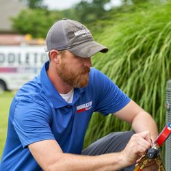 Middleton Heat & Air - Middleton HVAC technician performing service on a residential air conditioning unit