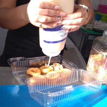 Javi Mini Donuts - a person pouring a drink into a container - Food Trucks Near Me - Kissimmee, Florida Javi Mini Donuts - a person pouring a drink into a container - Food Trucks Near Me - Kissimmee, Florida