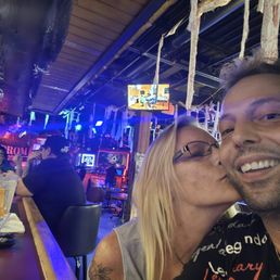 a man and a woman kissing at a bar a man and a woman kissing at a bar