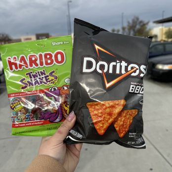 Walmart Supercenter - a hand holding a bag of doritoo chips - Grocery Near Me - Delano, California