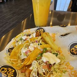 Baja Cali Fish & Tacos - Fish tacos and passionfruit beverage.