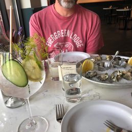 Happy hour oysters and a fun cocktail with tonic that had "serious peacocking" (sorry, forgot the drink name)