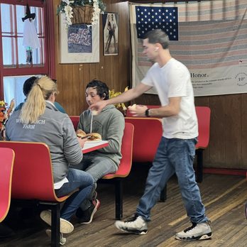 Finch's Country Store - a man serving food to a group of people - Grocery Near Me - Bedford, New York Finch's Country Store - a man serving food to a group of people - Grocery Near Me - Bedford, New York