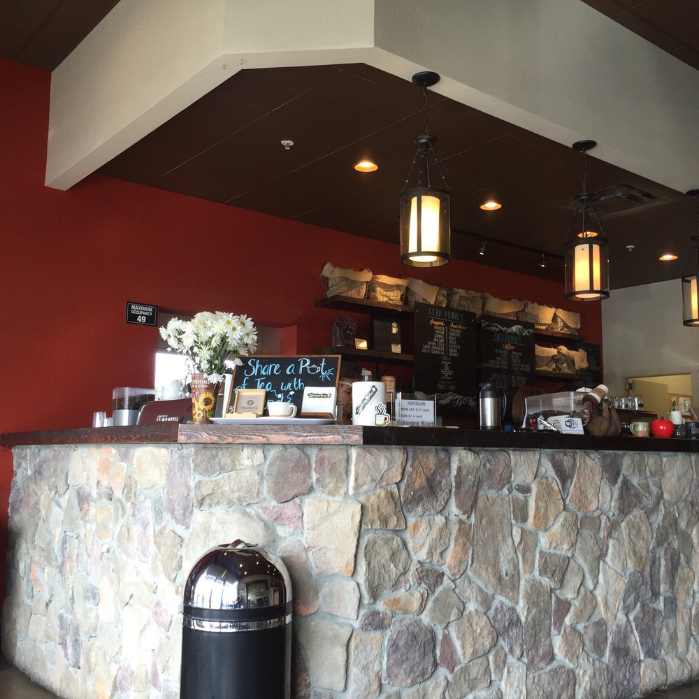 a stone bar with a vase of flowers on the counter a stone bar with a vase of flowers on the counter