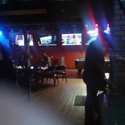 Locals Lounge - Back wall with three TVs and a pool table