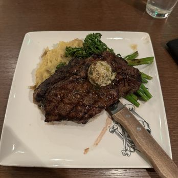 Guy Fieri's Cherokee Kitchen + Bar - Ribeye Steak with mashed potatoes and broccoli - New American Near Me - Cherokee, North Carolina Guy Fieri's Cherokee Kitchen + Bar - Ribeye Steak with mashed potatoes and broccoli - New American Near Me - Cherokee, North Carolina