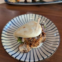 RAKKAN Ramen - Anaheim GardenWalk - Mushroom (vegetarian) bao appetizer, with husband's sushi in the background.