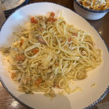 Red Lobster - A plate of creamy chicken Alfredo pasta with vegetables, served on a white dish at a restaurant, with a side of pasta in a bowl. - Seafood Near Me - Eugene, Oregon