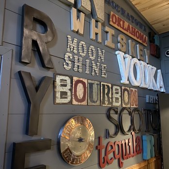 The Tasting Room - a variety of signs on the wall - Bars Near Me - Broken Bow, Oklahoma