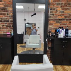 Prink Salon - A Leather very comfortable hair styling chair. PRINKS hair dryers hang from the ceiling.