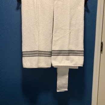Straight Arrow - two white towels hanging on a blue wall - General Contractors Near Me Straight Arrow - two white towels hanging on a blue wall - General Contractors Near Me