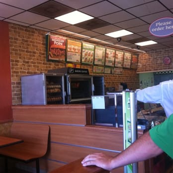 Subway - a man standing at a counter in a restaurant - Sandwiches Near Me - Montgomery, Texas Subway - a man standing at a counter in a restaurant - Sandwiches Near Me - Montgomery, Texas