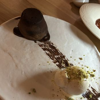 Manzzo Cuisine - TORTA AL CIOCCOLATO FONDENTE... Molten chocolate cake, served with vanilla ice cream. - Italian Near Me - Windermere, Florida