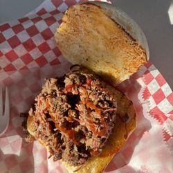 Texas Grub Wagon - Close-up of my sandwich with a drizzle of bbq sauce. Generous amount of meat. It is the BEST slow cooked, smokey flavor brisket in Texas.