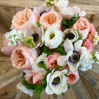 The Bloom Shoppe - My Bridal Bouquet - A floral bouquet featuring pink, white, and cream flowers with green foliage, arranged on a wooden table surface. - Florists Near Me - Temecula, California