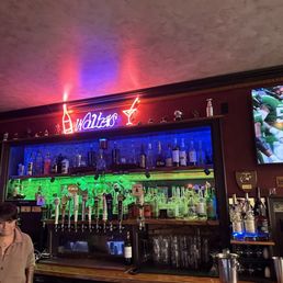 a man standing in front of the bar