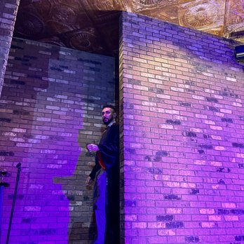 Desert Ridge Improv - a man standing in front of a brick wall - Comedy Clubs Near Me - Phoenix, Arizona Desert Ridge Improv - a man standing in front of a brick wall - Comedy Clubs Near Me - Phoenix, Arizona