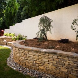 Hawkins Landscape Architecture - New Smoky Mountain veneer stone walls with new plantings and a water feature.