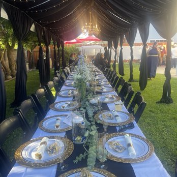 NPR Events and Decor - Tent with draping, lights & chandelier. Tables with linen and black chairs. - Party Equipment Rentals Near Me - Rialto, California NPR Events and Decor - Tent with draping, lights & chandelier. Tables with linen and black chairs. - Party Equipment Rentals Near Me - Rialto, California