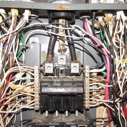 Romano Home Inspection - Corroded conductor to the left from water entering the service panel among other issues in this panel cabinet