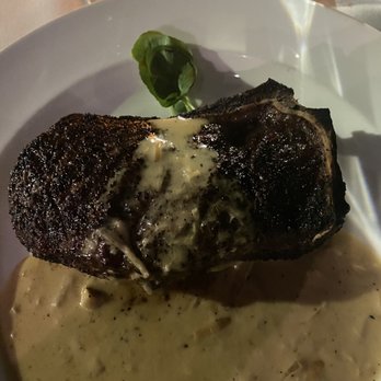 The Capital Grille - Bone-In Kona Crusted Dry Aged NY Strip with Shallot Butter - Steakhouses Near Me - Phoenix, Arizona