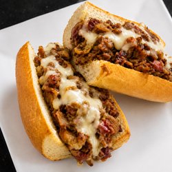 The Joker is our hot pastrami sandwich with provolone, pickles, and famous Joker sauce. Hot, melty, and packed with flavor at Green S