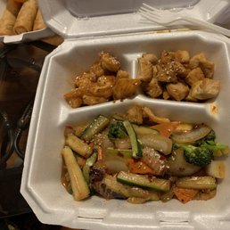 a takeout container with a variety of food items
