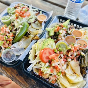 Tacos Ameca - two trays of tacos on a picnic table - Mexican Near Me - Gilroy, California Tacos Ameca - two trays of tacos on a picnic table - Mexican Near Me - Gilroy, California