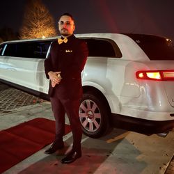 Access Line Transportation - A luxurious white stretch limousine decorated for a wedding.