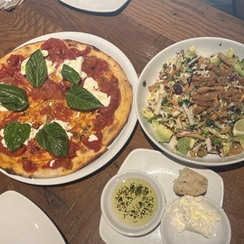 California Pizza Kitchen - Left - Thin Crust Burrata with Spicy Pepperoni & Right - Thai Crunch Salad with Avocado - Pizza Near Me - Long Beach, California California Pizza Kitchen - Left - Thin Crust Burrata with Spicy Pepperoni & Right - Thai Crunch Salad with Avocado - Pizza Near Me - Long Beach, California