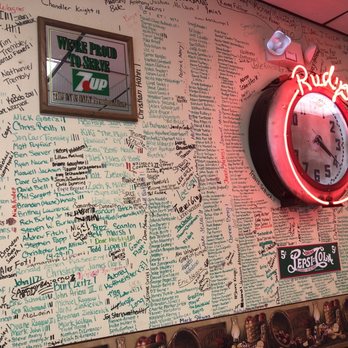 Rudy's - a wall of writing and a neon clock - Diners Near Me - Medina, New York