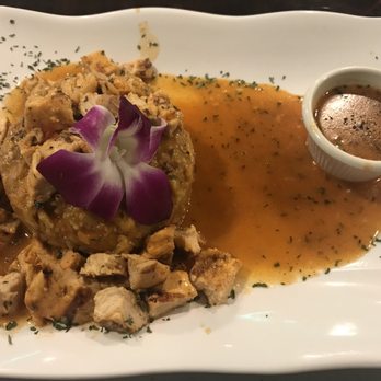 Tainos Cafe & Lounge - Chicken Mofongo with green plantains. Served with garlic-buttery sauce. Does not come with any sides. - Latin American Near Me - Coram, New York Tainos Cafe & Lounge - Chicken Mofongo with green plantains. Served with garlic-buttery sauce. Does not come with any sides. - Latin American Near Me - Coram, New York