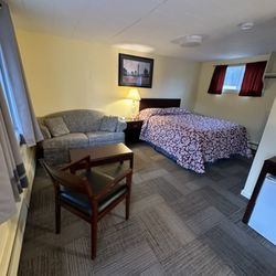 Giovanni's Red Rose Motel - Queen bed and pullout couch side chair.