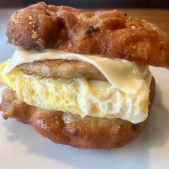 Just 1 Bite Too - Grilled apple fritter with sausage Patty, eggs, and American cheese - American Near Me - Mattydale, New York Just 1 Bite Too - Grilled apple fritter with sausage Patty, eggs, and American cheese - American Near Me - Mattydale, New York
