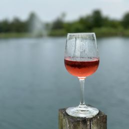 a glass of wine sitting on a post a glass of wine sitting on a post