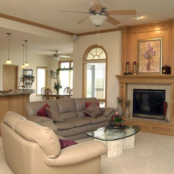 Omaha Drywall - living room with fireplace and kitchen in background - General Contractors Near Me