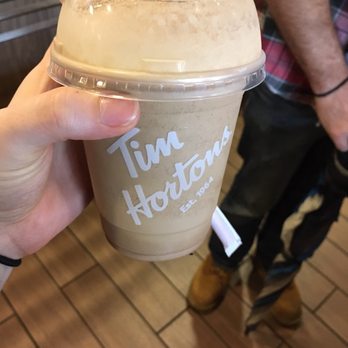 Tim Hortons - a hand holding a cup of coffee - Donuts Near Me - Ellicottville, New York Tim Hortons - a hand holding a cup of coffee - Donuts Near Me - Ellicottville, New York
