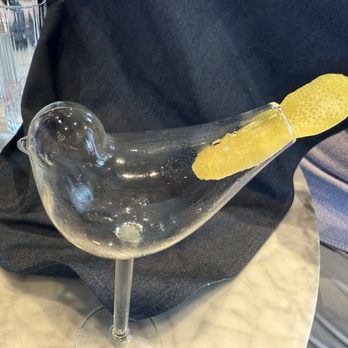 Margaux Brasserie - Empty bird glass with lemon peel tail - French Near Me - Brookfield, Wisconsin