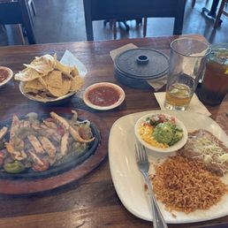 Mesquite Grilled Chicken Fajitas Refried Beans, Spanish Rice, Guacamole, Pico, Shredded Cheese, Flour Tortillas, Chips/Salsa. Unsweet Tea.