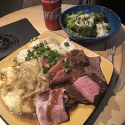 Ham & Roast Beef w/ Perogies, grilled Onions & mashed Potatoes. A side bowl of Broccoli and Cauliflower.