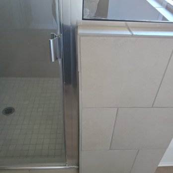 Omega Builders - The tile gets wider towards the top. The shower door installer decided to install the door anyway. It looks really bad in person. - Real Estate Services Near Me - Temple, Texas