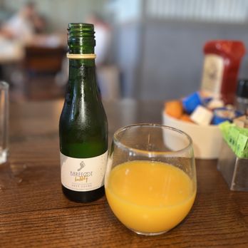 First Watch - a glass of orange juice next to a bottle of wine - Breakfast & Brunch Near Me - Oak Brook, Illinois First Watch - a glass of orange juice next to a bottle of wine - Breakfast & Brunch Near Me - Oak Brook, Illinois