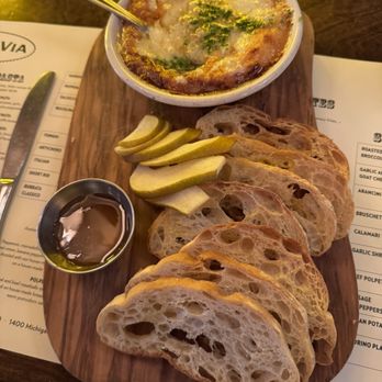 Ottava Via - Pecorino plate. Pecorino cheese al forno with Italian bread, pears, and spiced truffle honey - Pizza Near Me - Detroit, Michigan Ottava Via - Pecorino plate. Pecorino cheese al forno with Italian bread, pears, and spiced truffle honey - Pizza Near Me - Detroit, Michigan