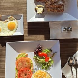 Avocado toast with egg on the side and grits. Of course they're French toast too. Yummy!