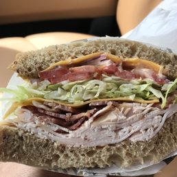 a person holding a sandwich a person holding a sandwich