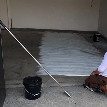 California Floor Covering - a man painting a garage floor - Flooring Near Me - Chatsworth, California