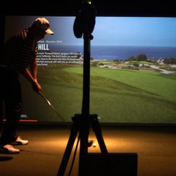 The Golf Warrior - Simulator loading up a course whilst Jay Graham is practicing his swing.