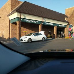 a car parked in front of a pharmacy